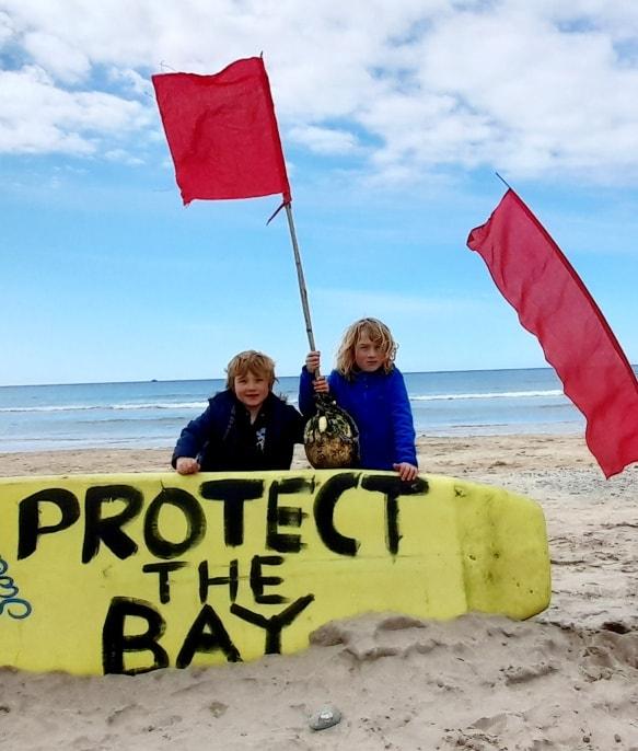 Protect the Bay banners and protest
